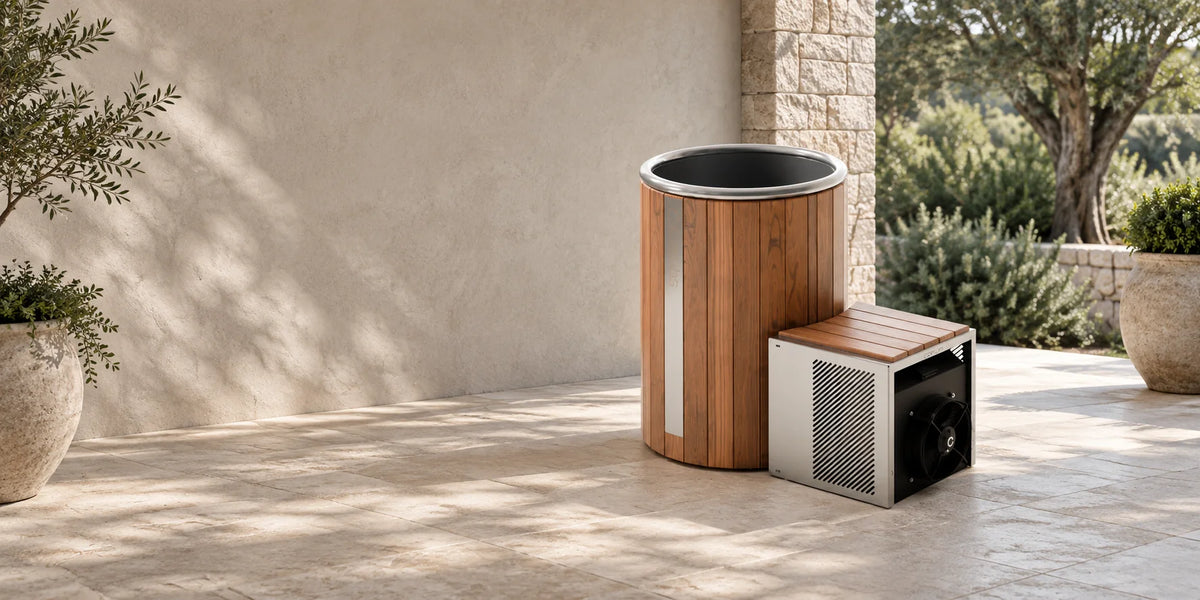 SOVRA cold plunge kit — wooden tub and chiller unit on a stone terrace. Illustrative staging based on the product photo.